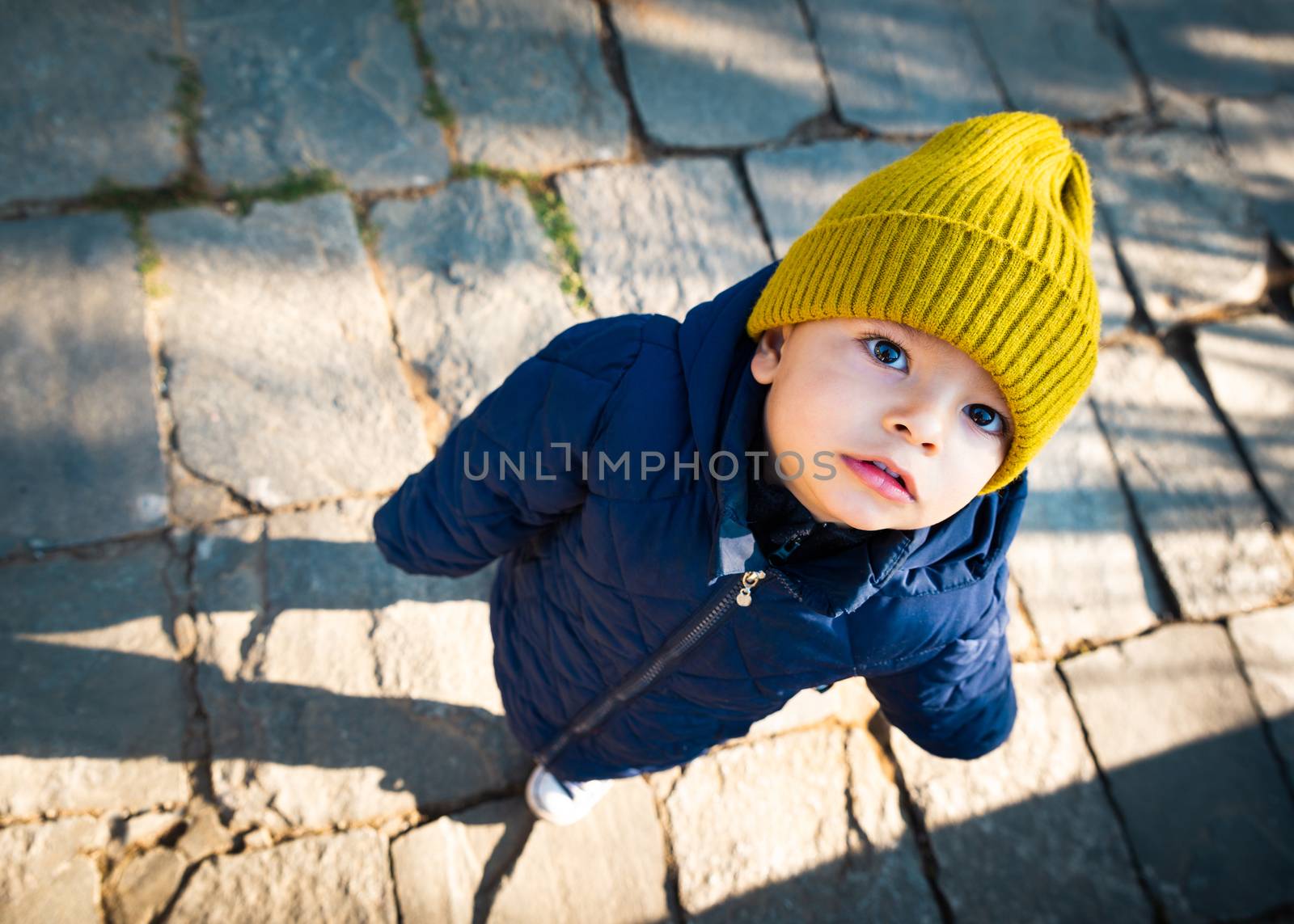 Eurasian baby looking up at the camera.