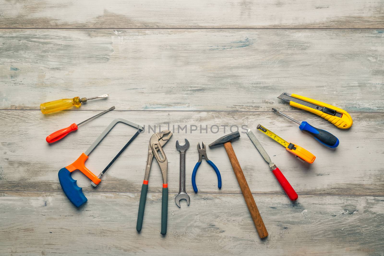 Screwdriver,hammer,tape measure and other tool for construction tools on gray wooden background with copy space,industry engineer tool concept.still-life.