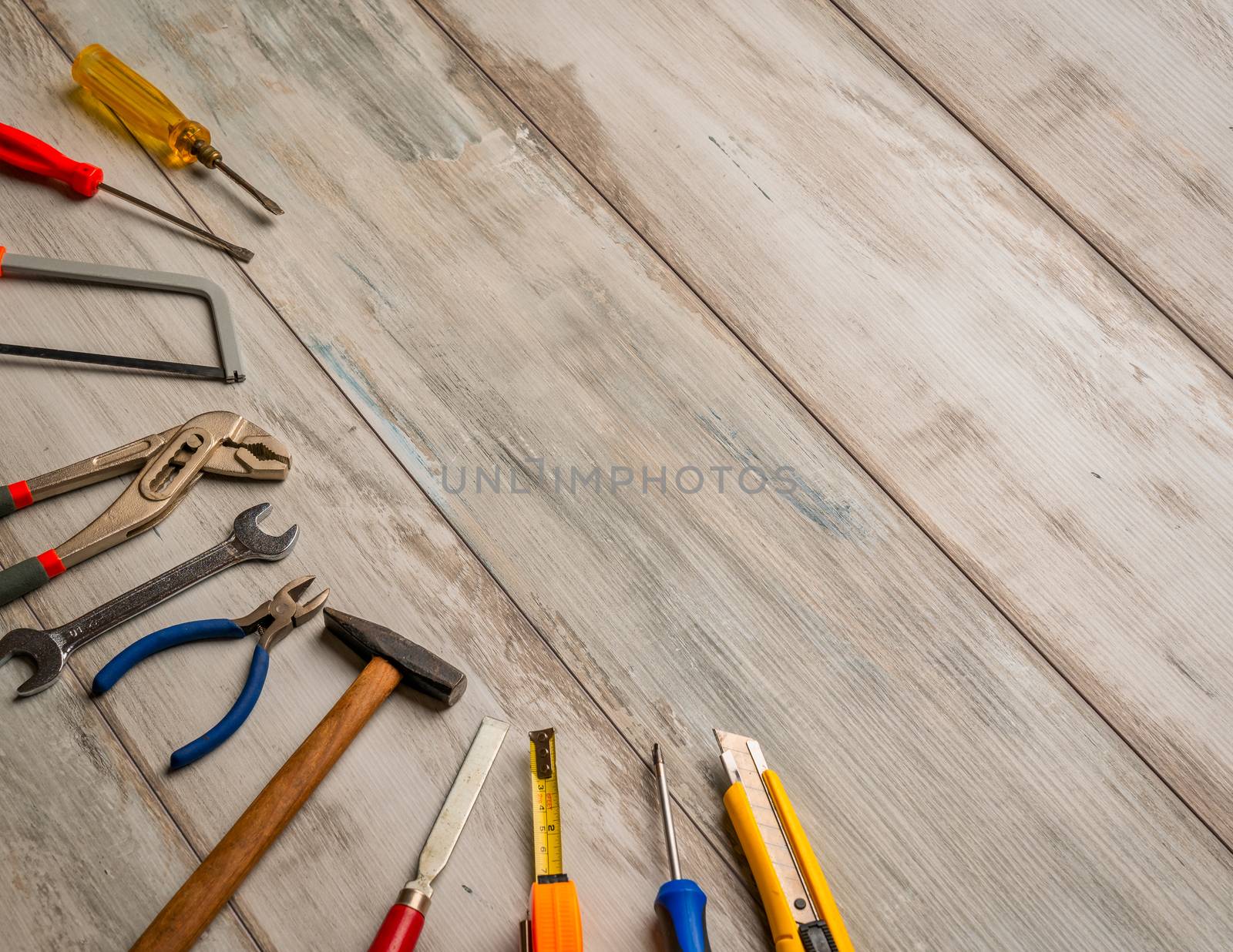 Screwdriver,hammer,tape measure and other tool for construction tools on rustic wooden background with copy space,industry engineer tool concept.still-life.