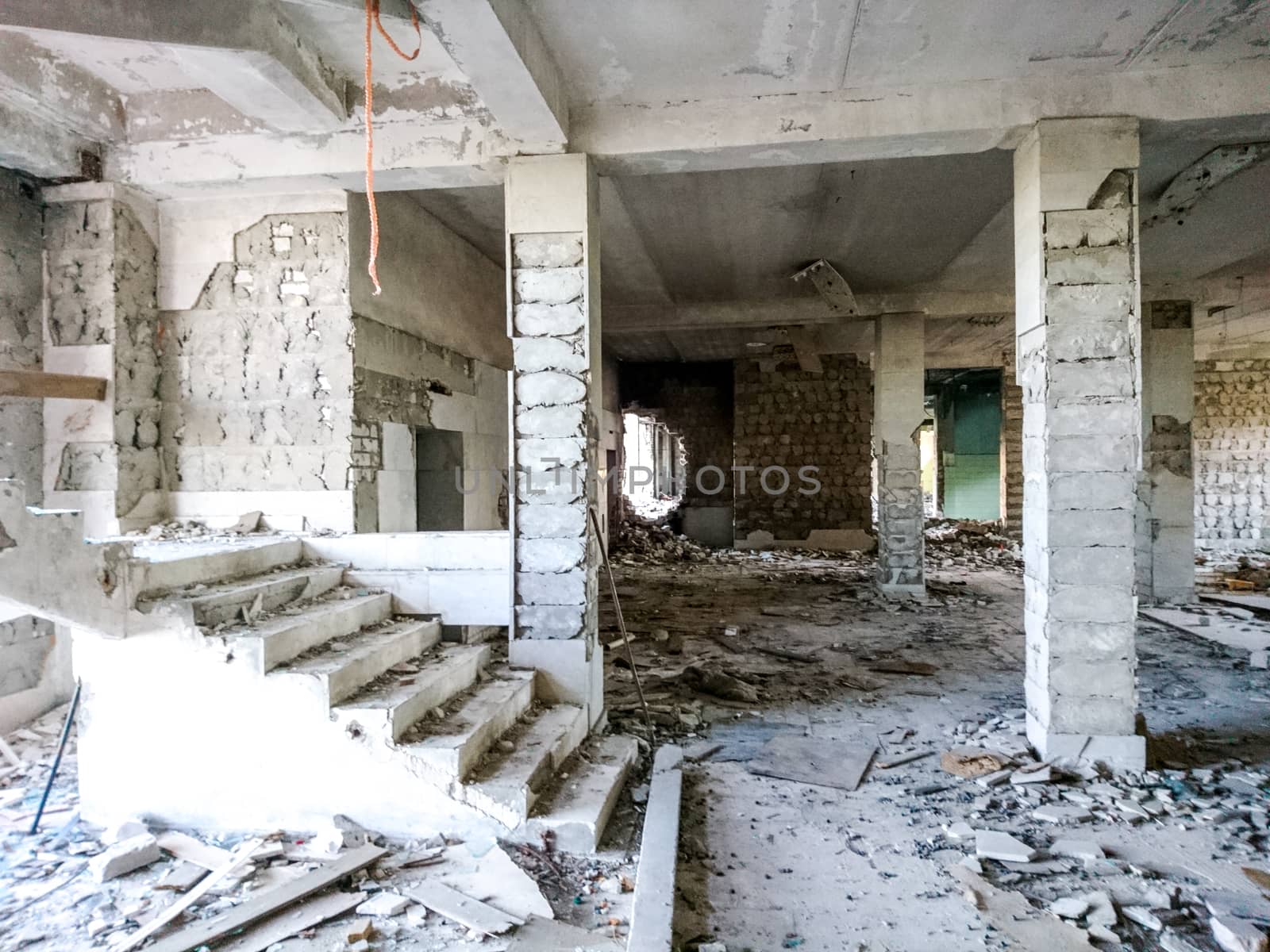 The ruins of a large destroyed building, pieces of stone, concrete, clay and metal