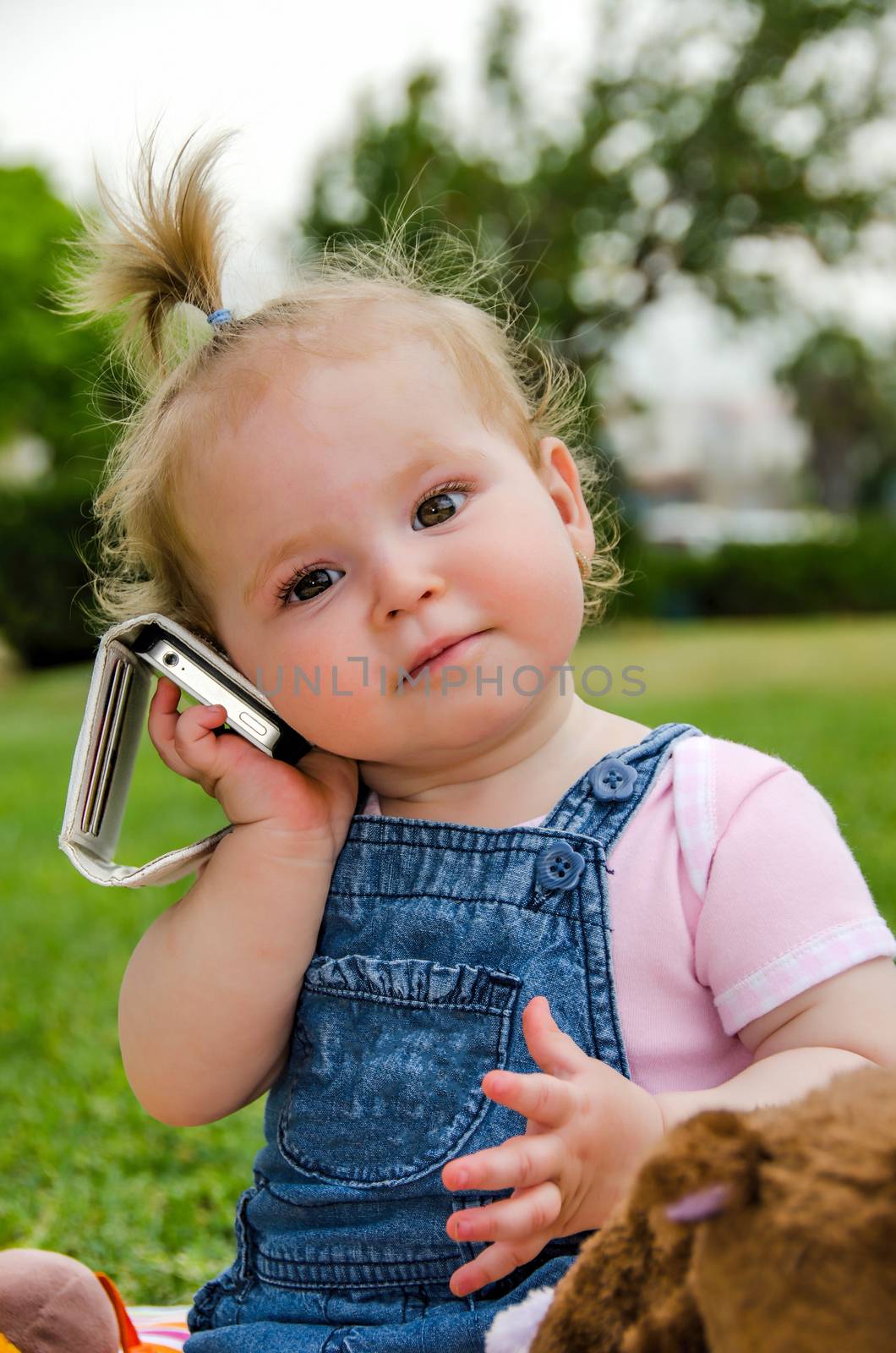 Child listens to music on a mobile phone. by ben44