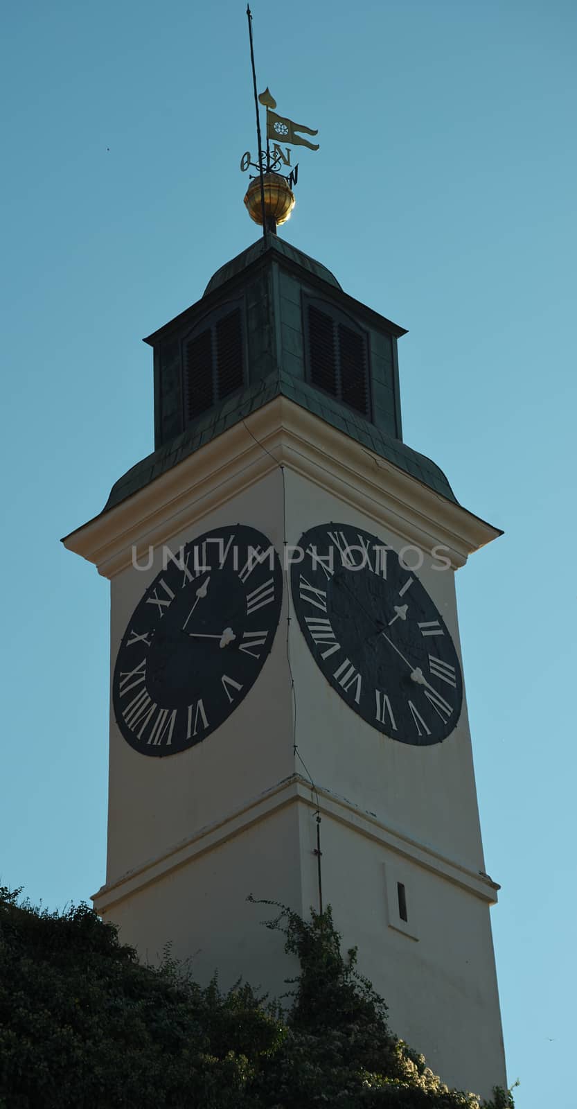 Clock tower with small bell tower at top in Novi Sad, Serbia by sheriffkule