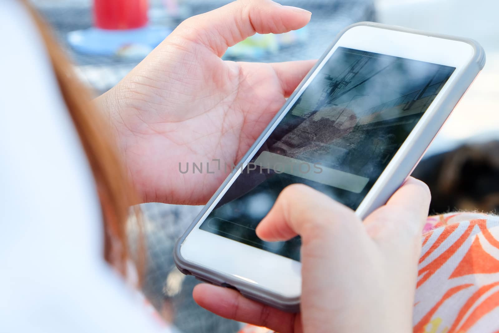 Teenage girl using white mobile phone