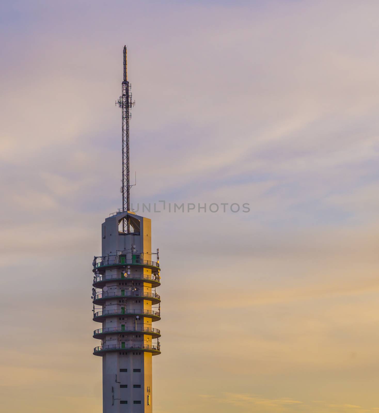 signal transmitting tower with a colorful sky full of clouds, telecommunication technology and architecture