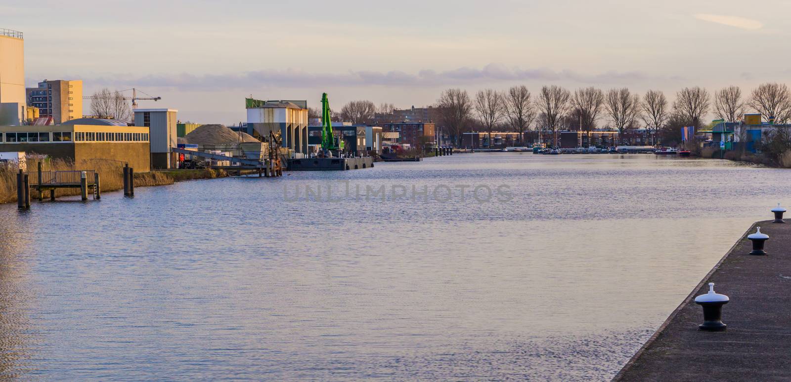 Industrial zone at the water side of Alphen aan den Rijn, The Netherlands, city scenery of a well known dutch city by charlottebleijenberg