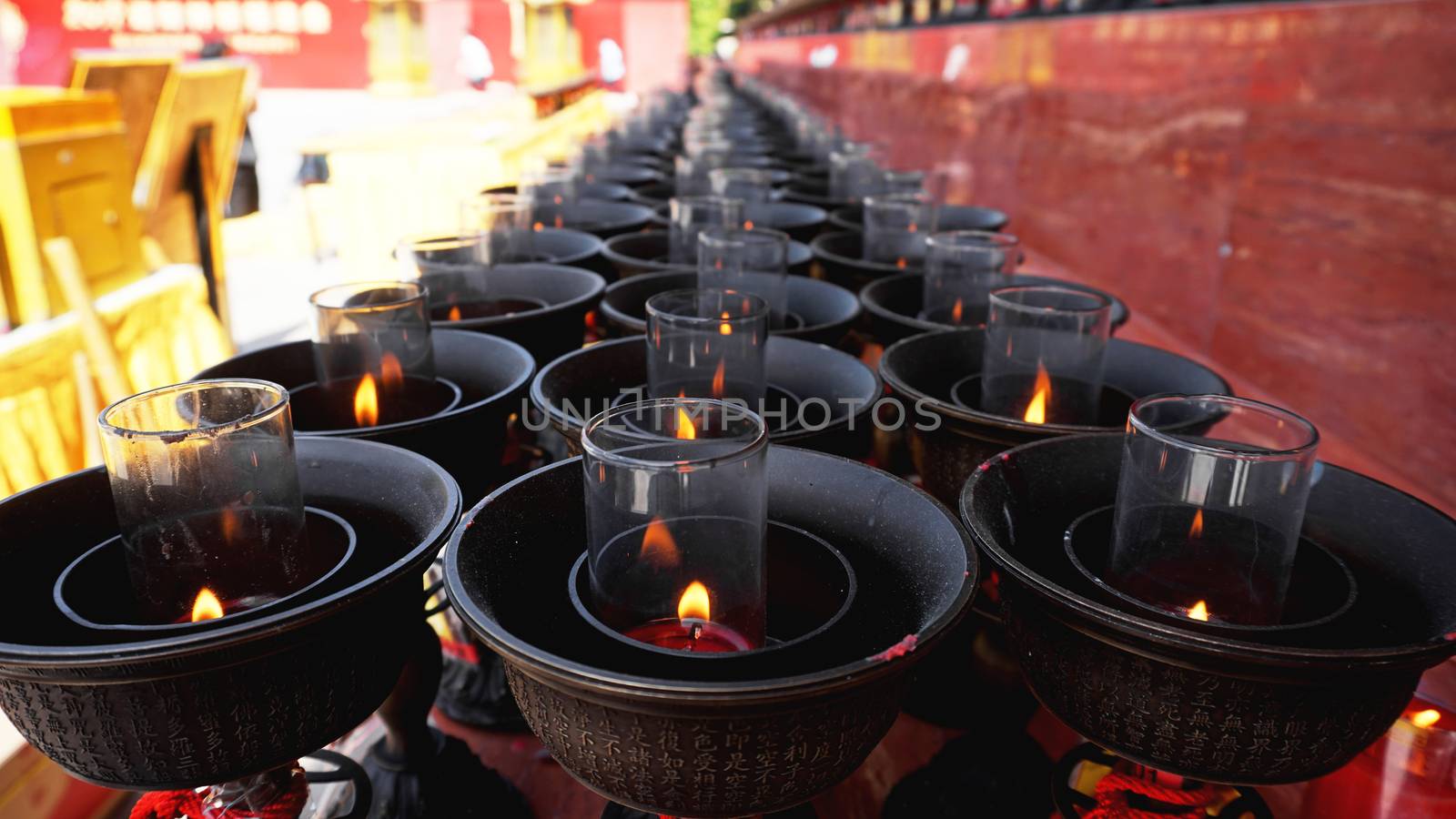 Burning big red candles in Buddhist temple in China