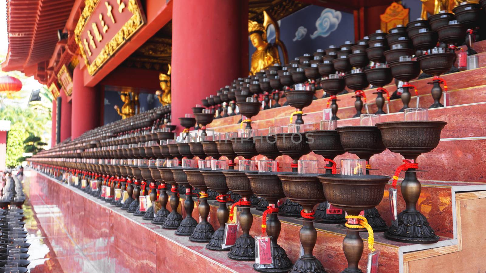 Burning big red candles in Buddhist temple in China