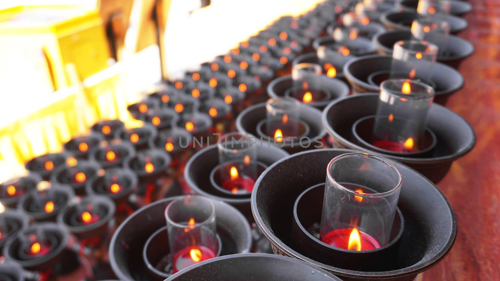 Burning big red candles in Buddhist temple in China