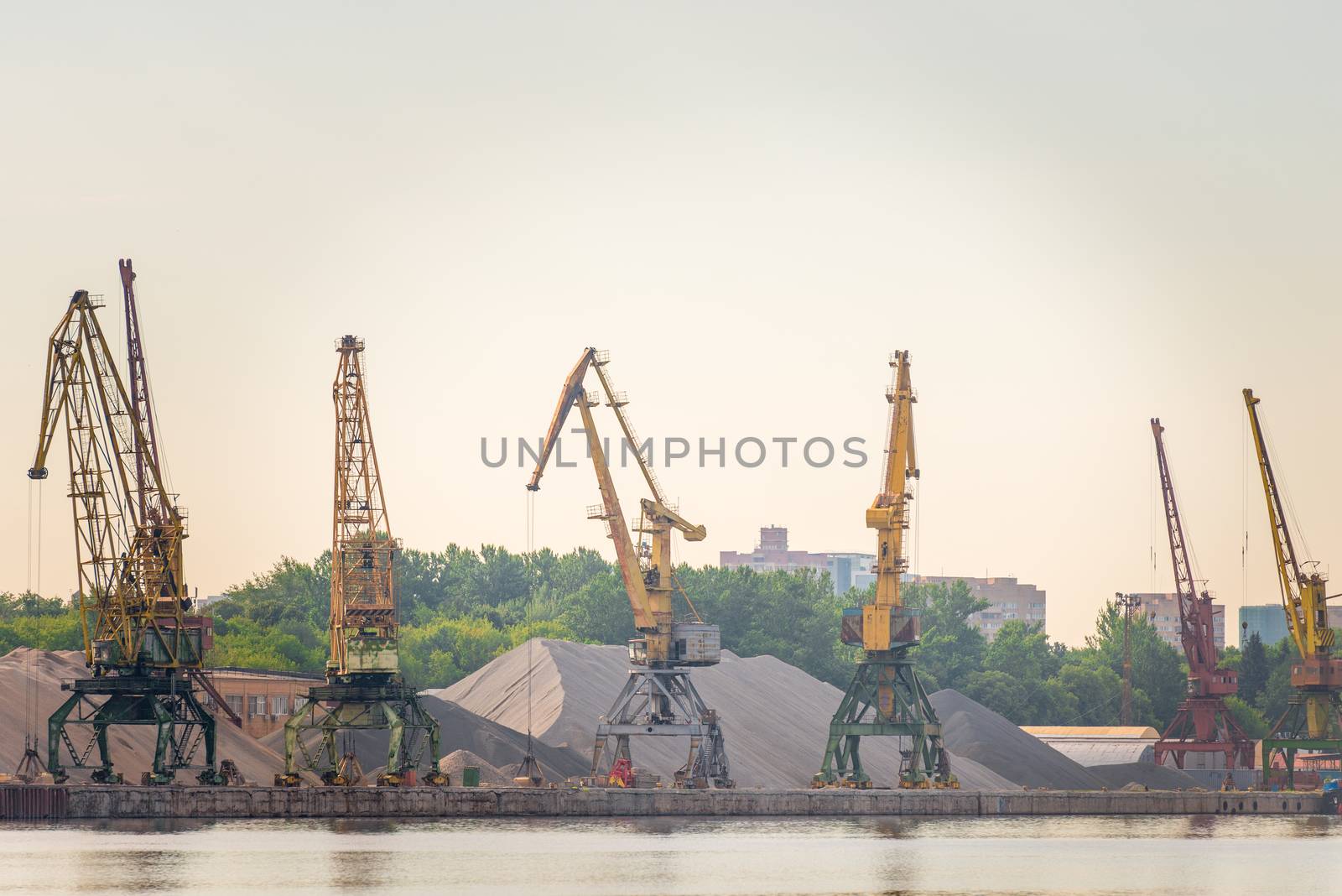 Port loaders and rubble heaps at sunrise by kosmsos111