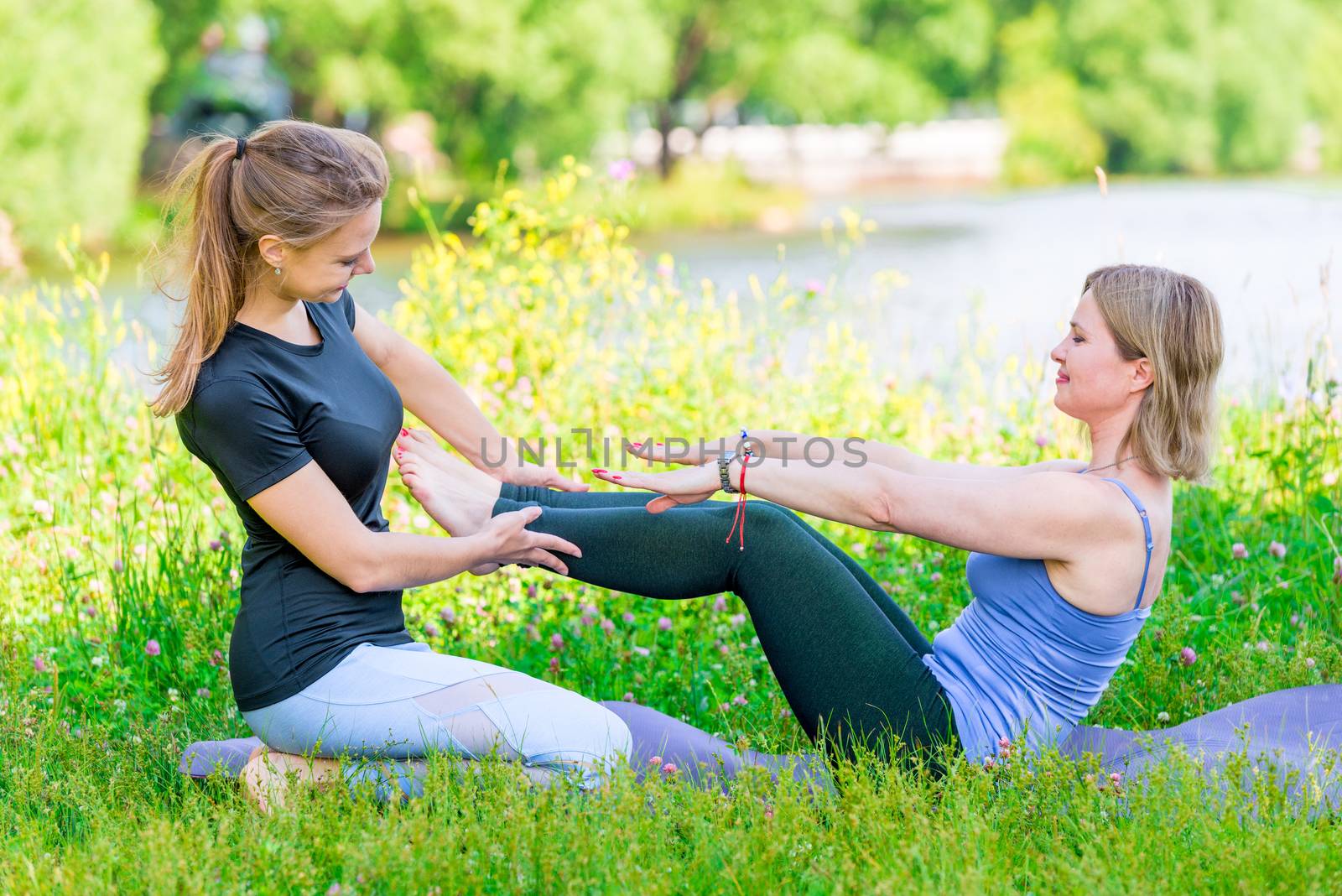 yoga exercise with an individual experienced trainer in the park by kosmsos111