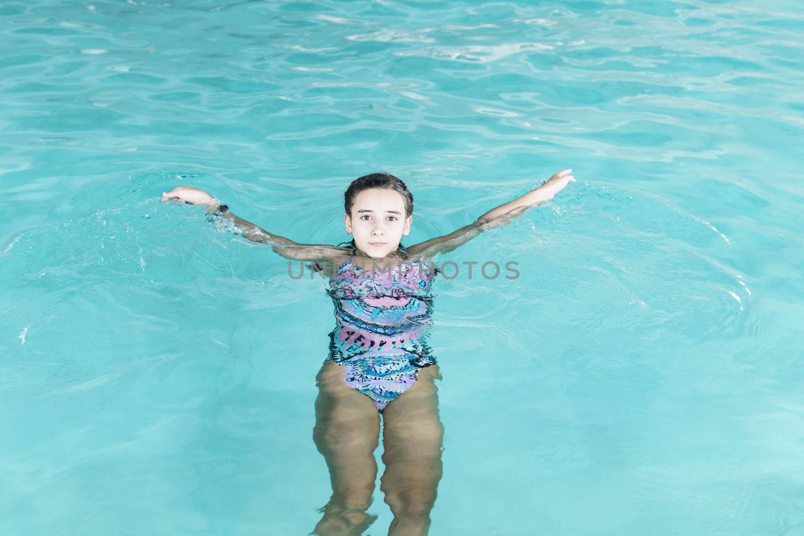 Beautiful girl swim and having fun in water.Active holiday.Girl swim in the pool. Happy girl play in the pool.