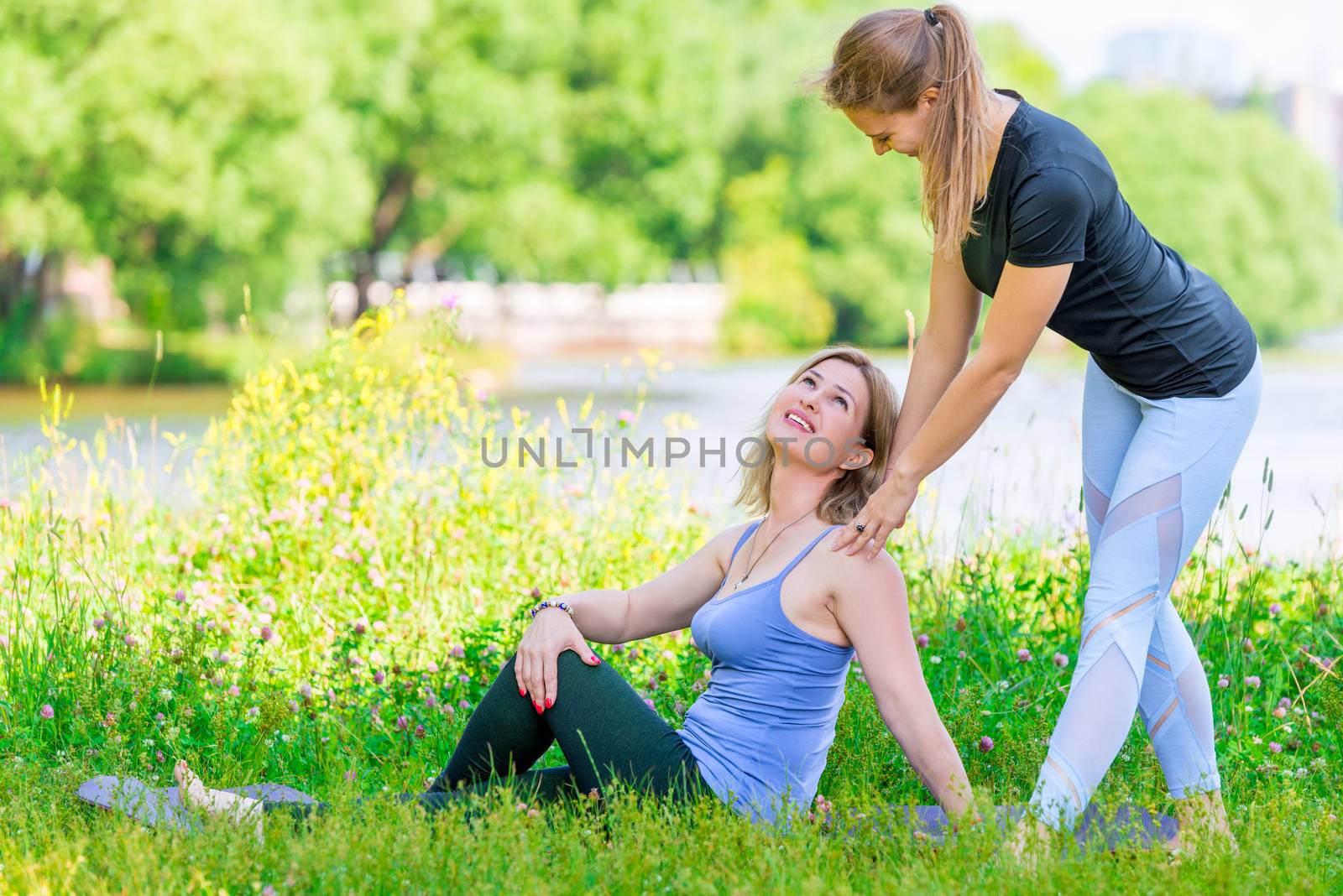 happy women during a yoga break in the park