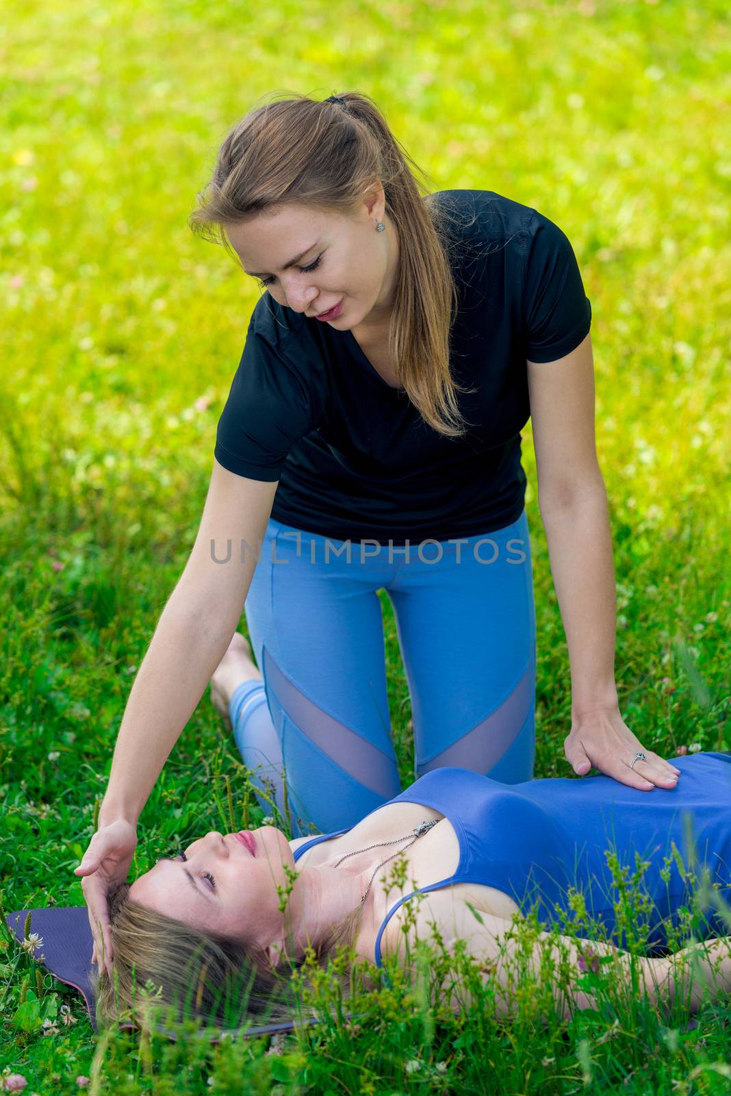 coach girl controls woman's breathing exercises during yoga, sho by kosmsos111