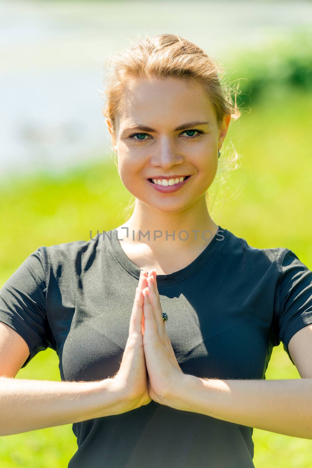 Yoga trainer welcomes in class. portrait in the park