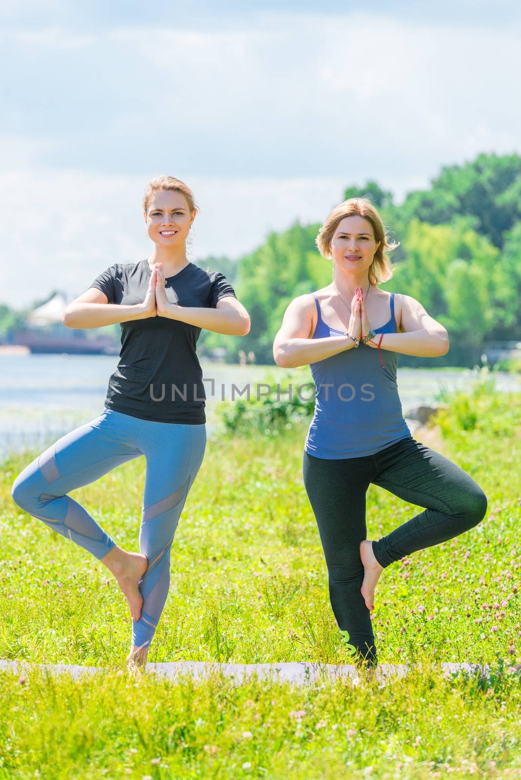 yoga classes with an individual trainer, balance on one leg on a sunny day in the park