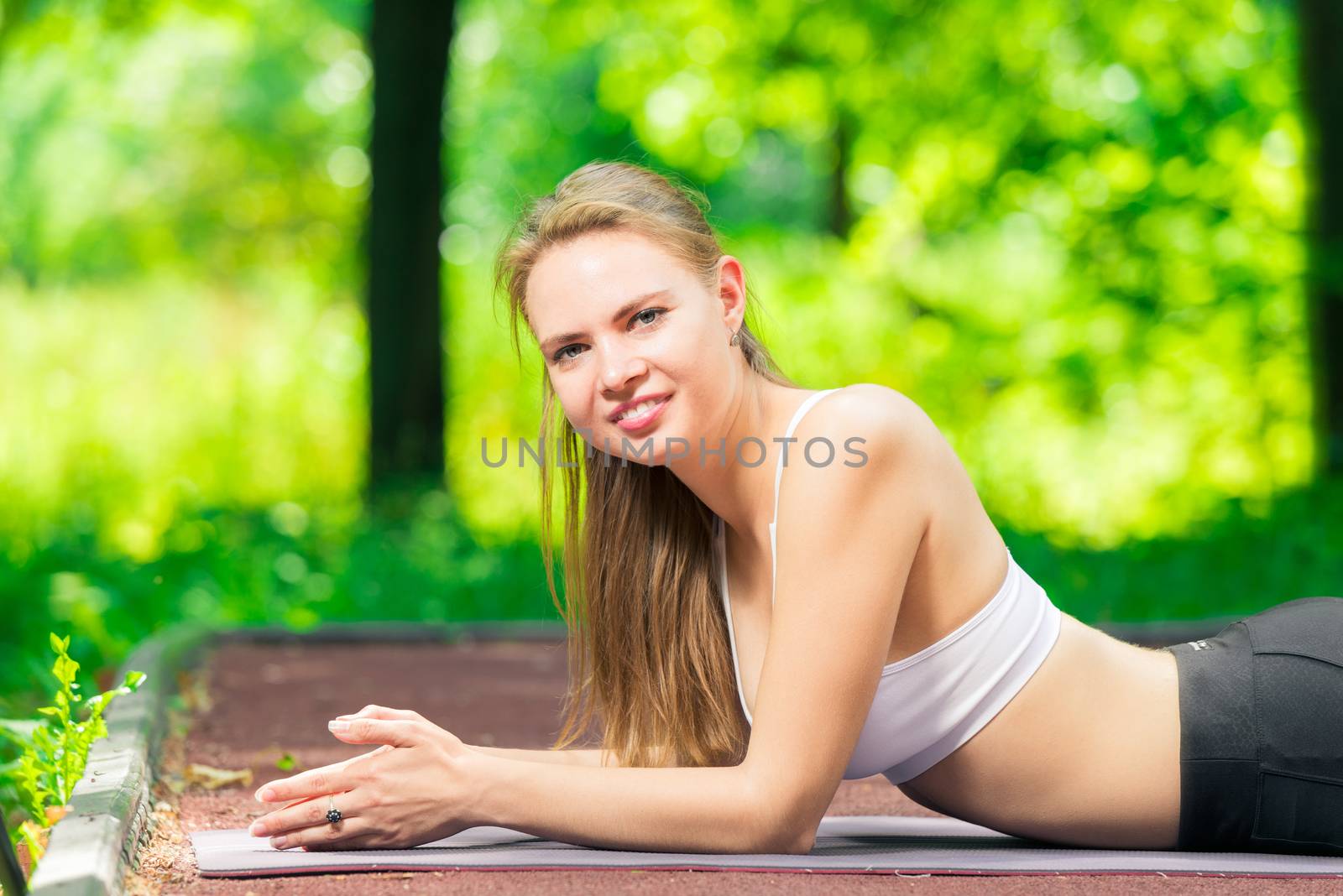 portrait of an active girl outdoor pilates trainer in training by kosmsos111