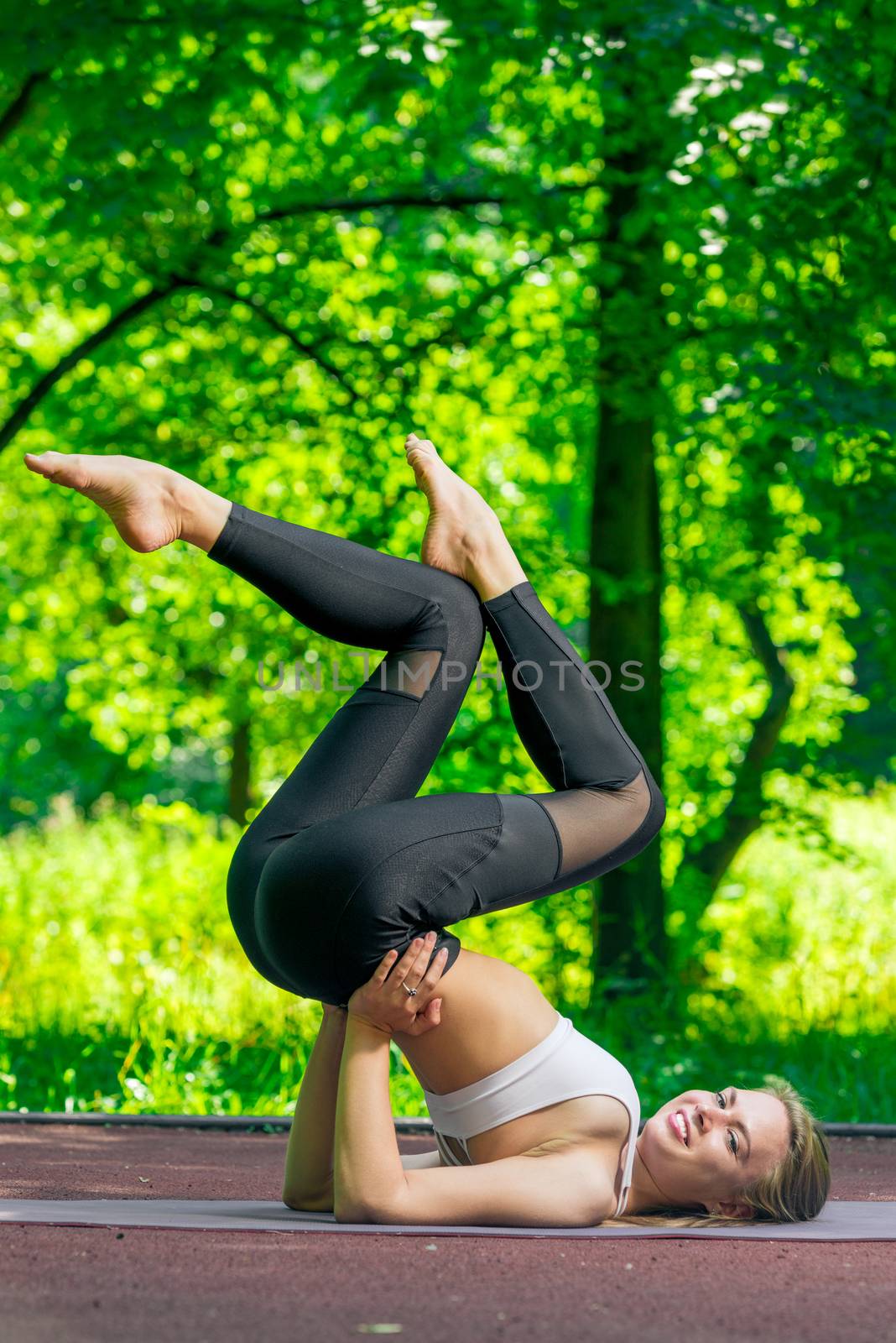 active and beautiful girl goes in for sports in the summer park by kosmsos111