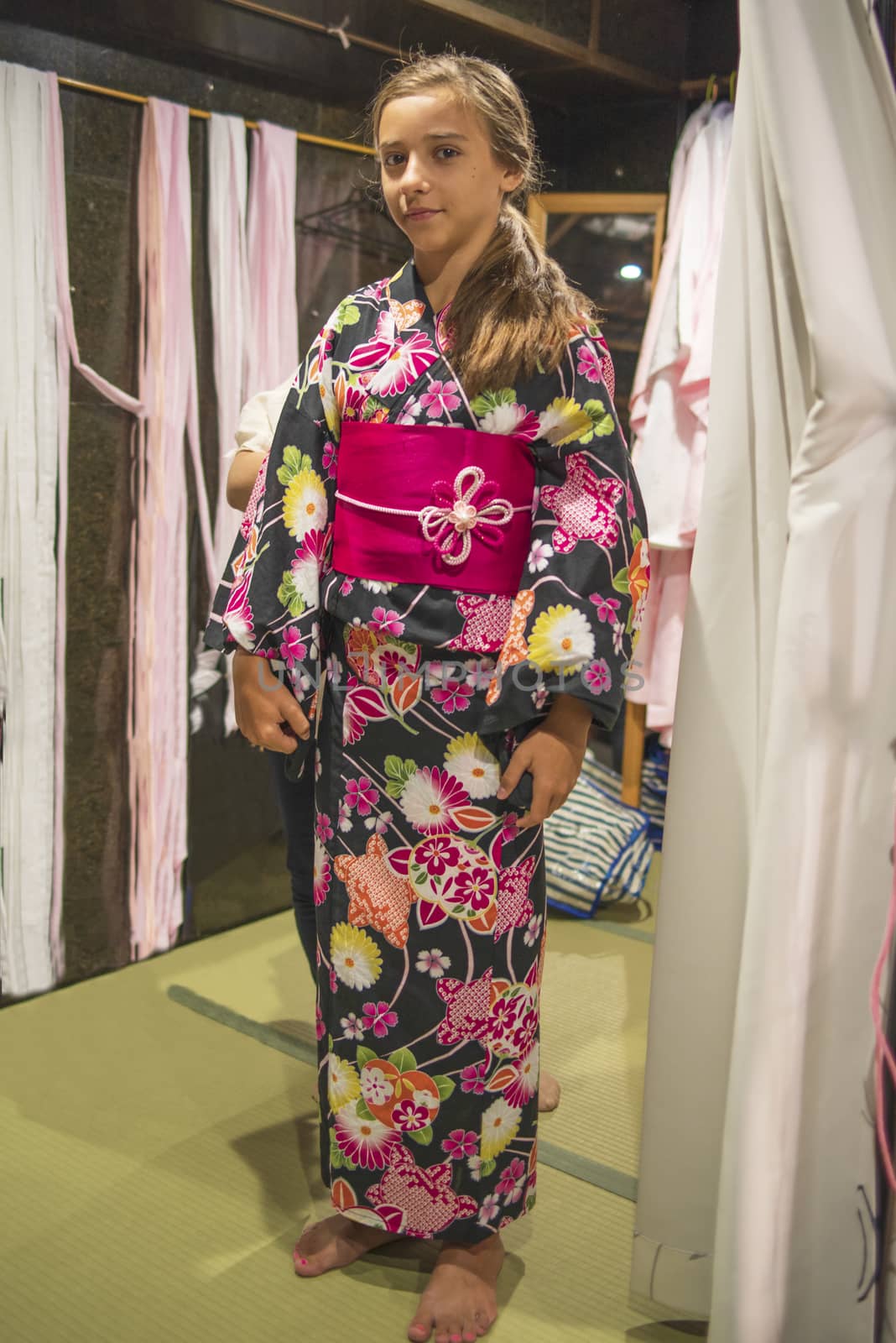 A pretty girl in a kimono. Kimono is the traditional dress worn popular in Japan.European girl in kimono.Portrait of girl wearing japanese traditional kimono .