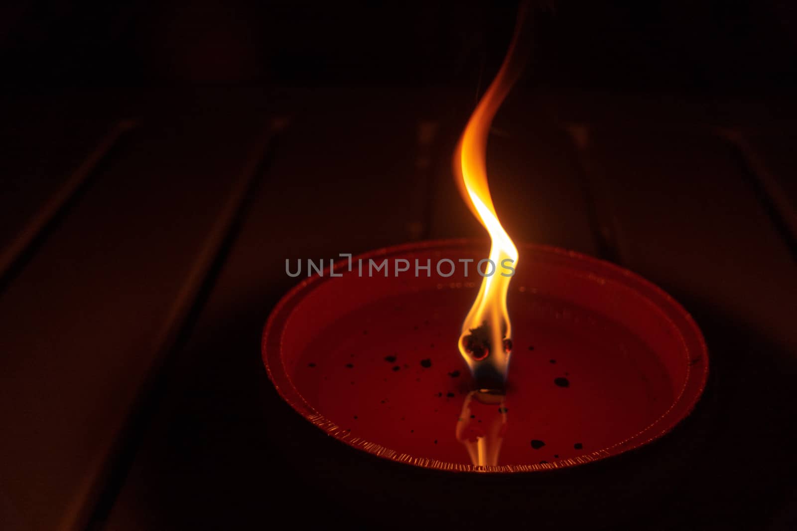 Candle flame close up on dark background, interesting flame figure, candle fire shape, horizontal