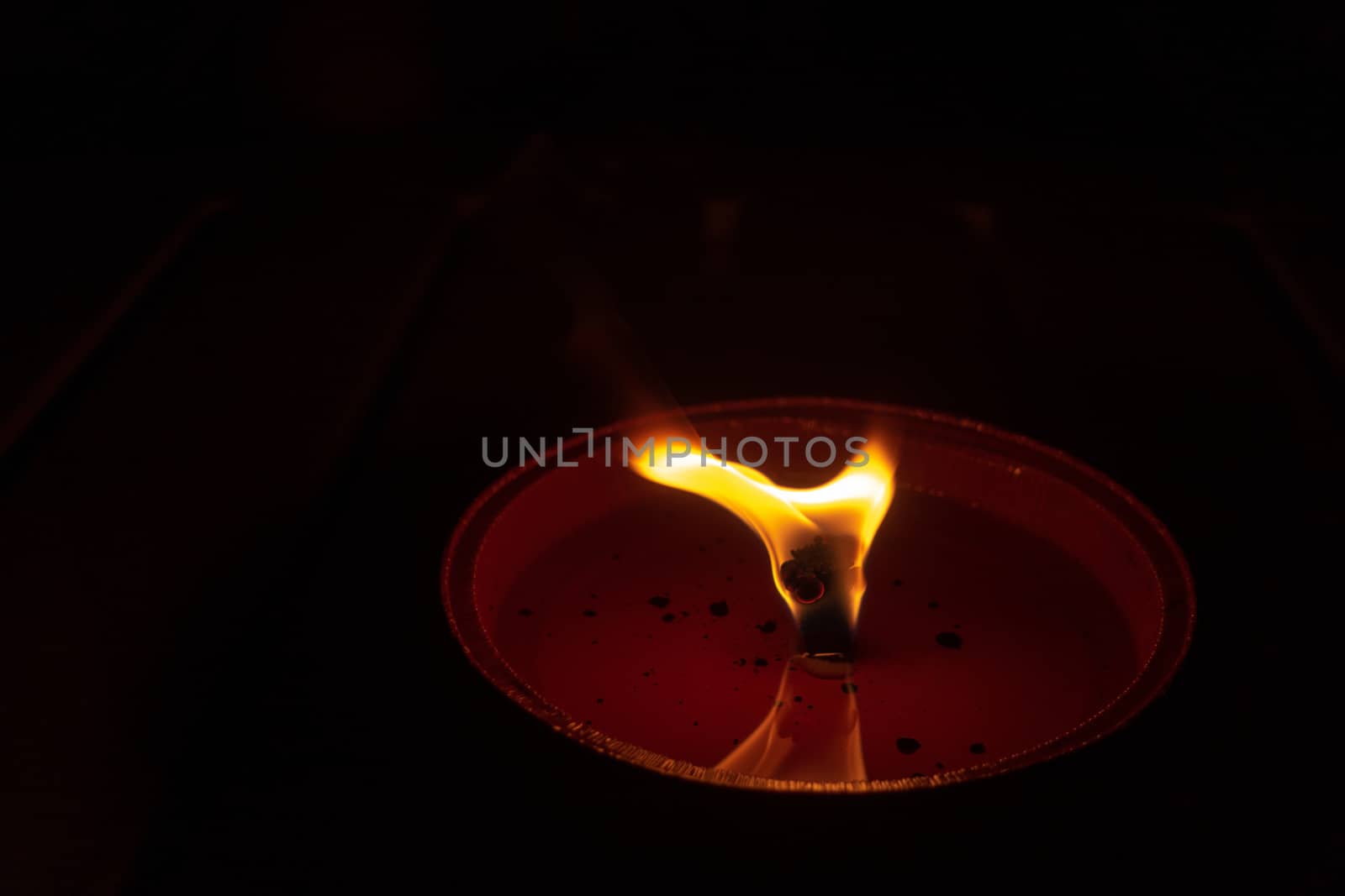 Candle flame close up on dark background, interesting flame figure, candle fire shape split on top