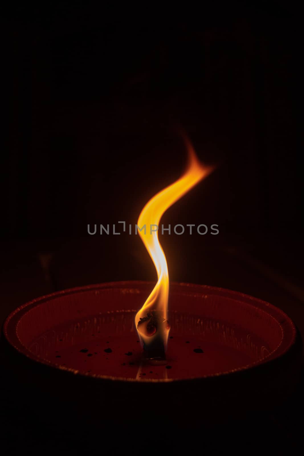 Candle flame close up on dark background, interesting flame figure, candle fire shape s form