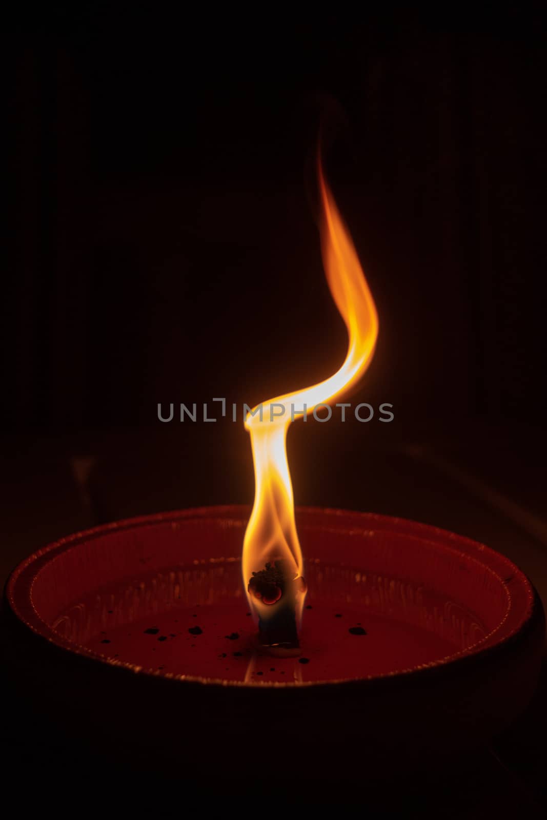 Candle flame close up on dark background, interesting flame figure, candle fire shape abstract