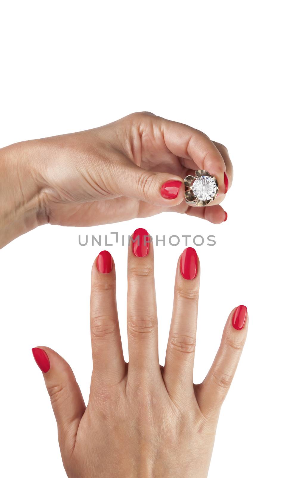 Female hands with red manicure wear a silver ring, isolated on white background