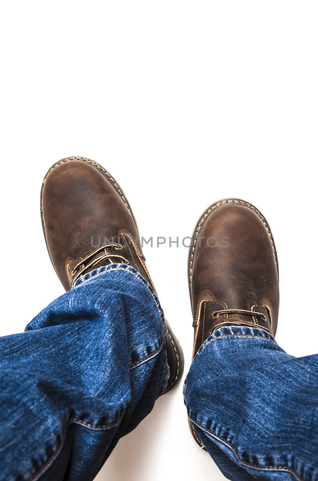 Men's brown boots and blue jeans. Isolated on white bacground