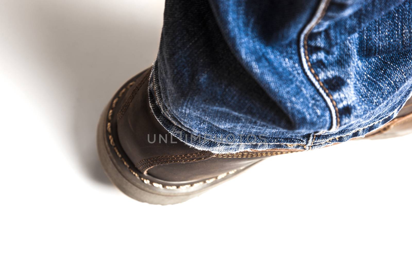 Men's brown boots and blue jeans. Isolated on white bacground