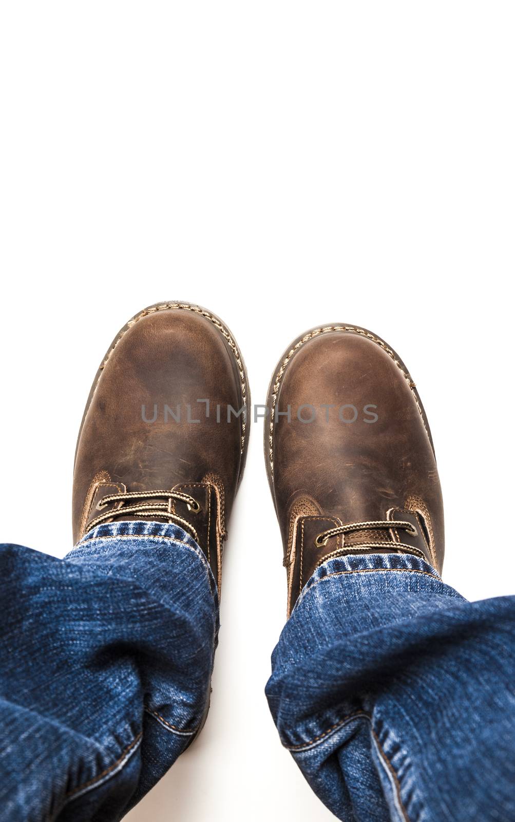 Men's brown boots and blue jeans. Isolated on white bacground