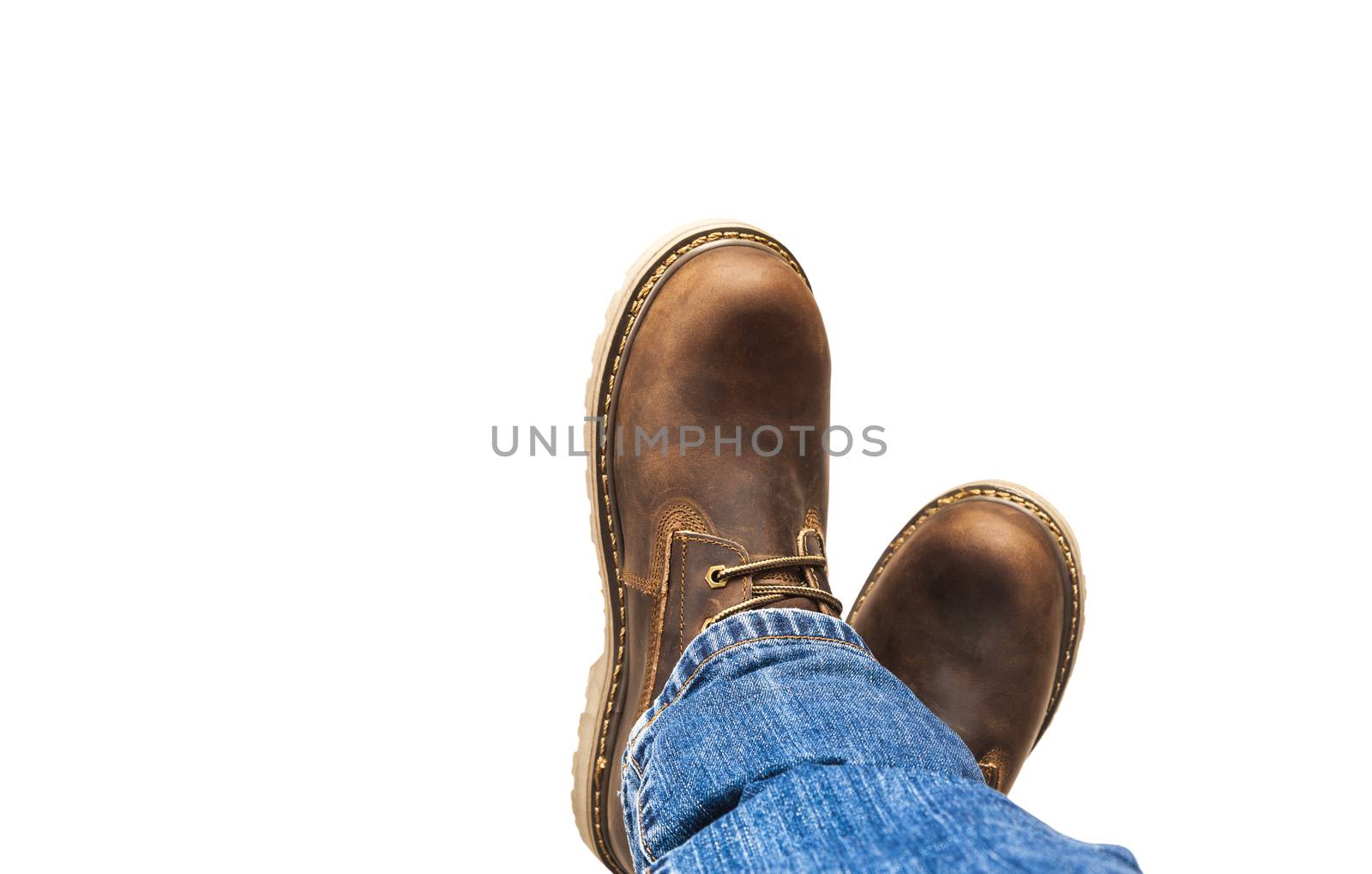 Men's brown boots and blue jeans isolated by SlayCer