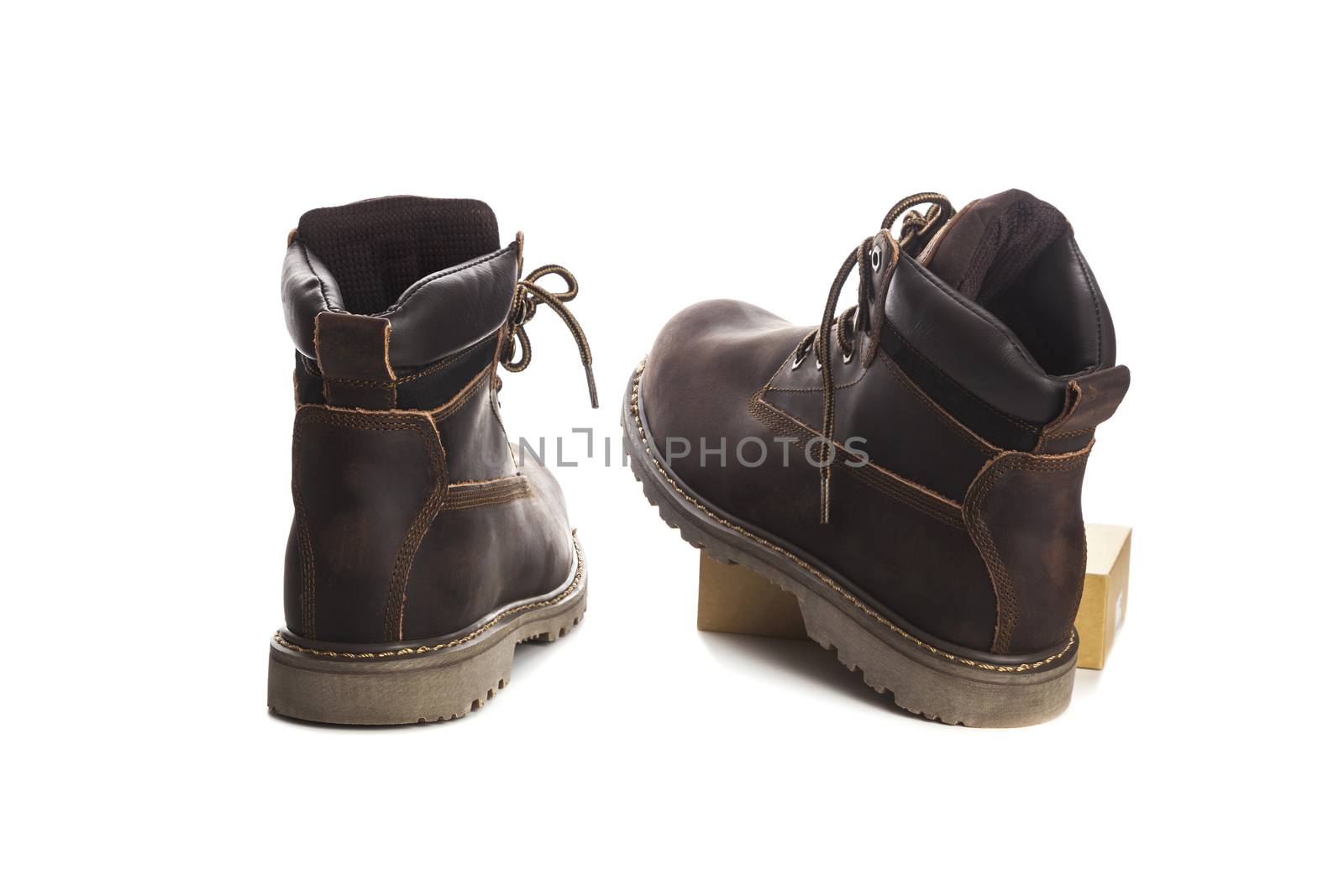 Man ankle boots, brown color, with nubuck leather. Isolated on white background, closed up