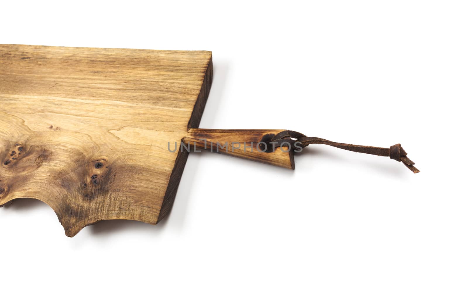 Surface of the old wooden planks kitchen board with leather strap, isolated on white background