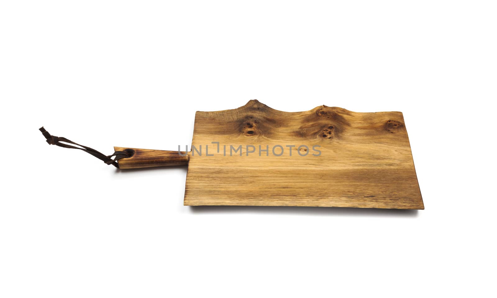 Surface of the old wooden planks kitchen board with leather strap, isolated on white background