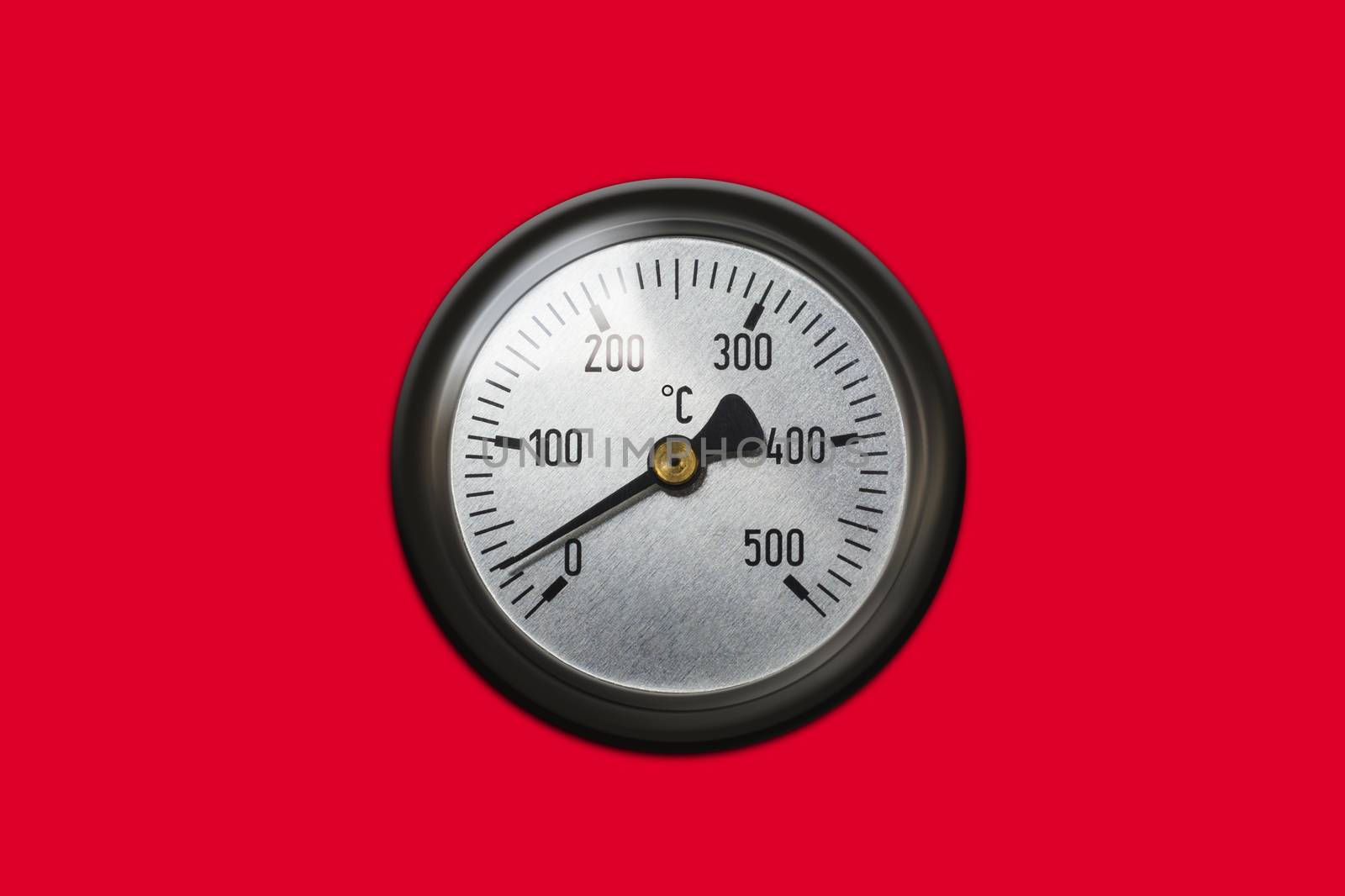 Celsius thermometer temperature gauge from a heater isolated on red background. With clipping path