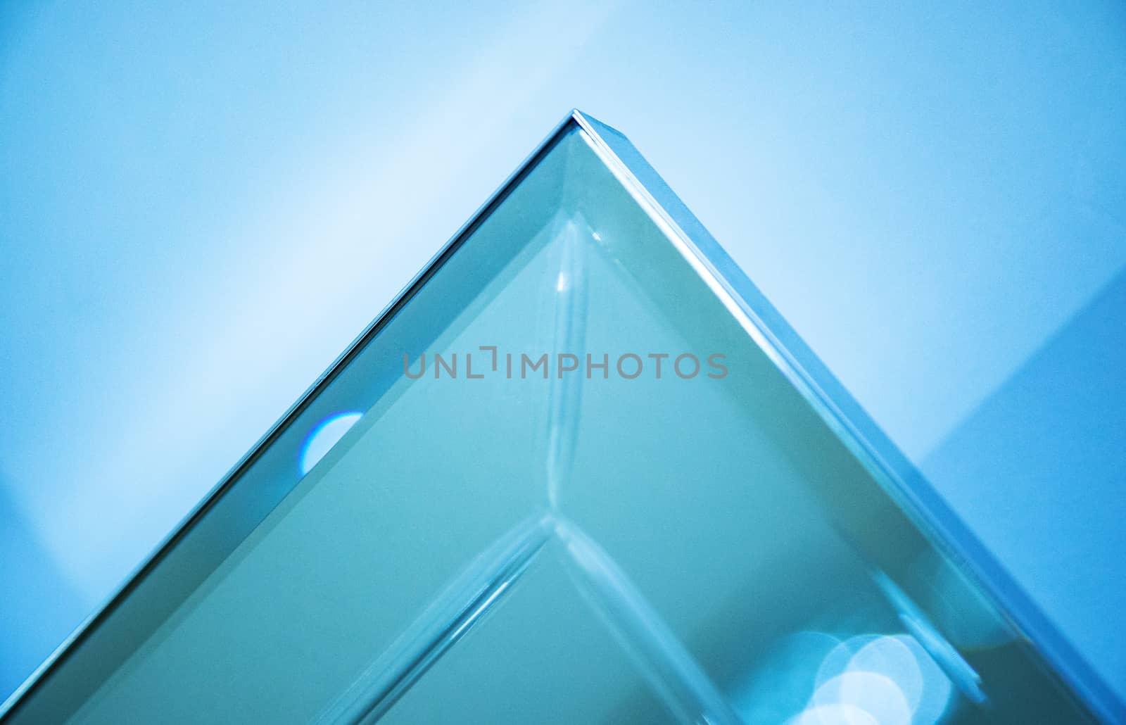 Glass, mirror reflection shapes and shadows. Close-up details.  Abstract geometric design with parallel and intersecting lines. Graphical representation of angle