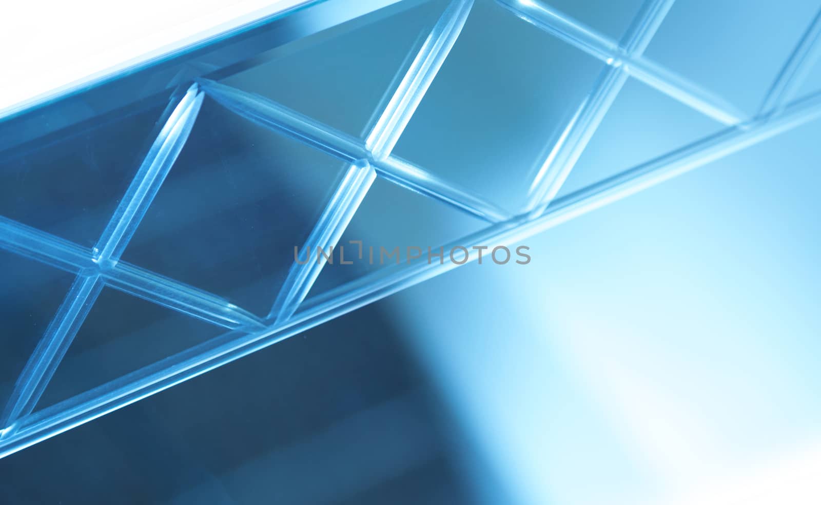 Glass, mirror reflection shapes and shadows. Close-up details.  Abstract geometric design with parallel and intersecting lines. Graphical representation of angle