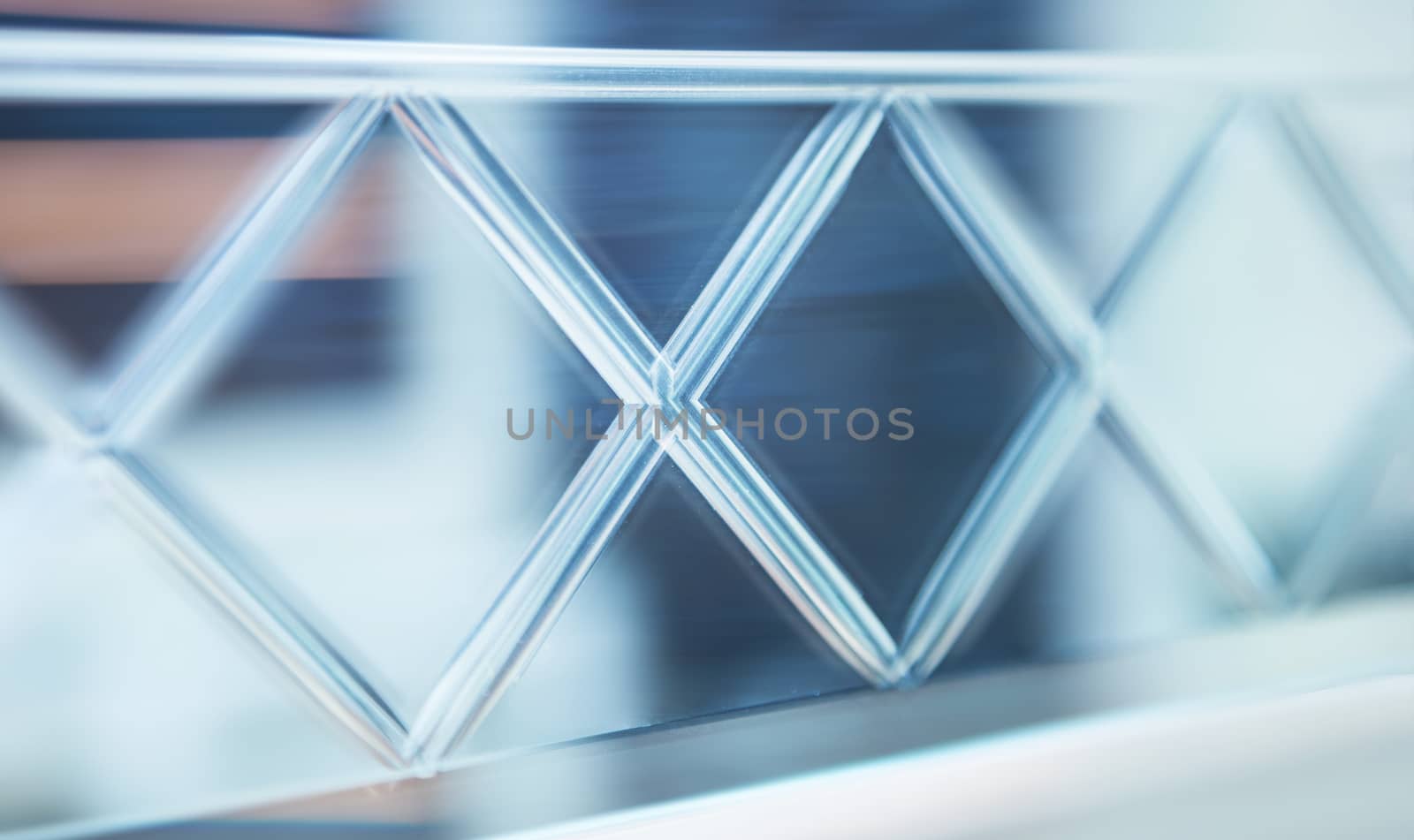 Glass, mirror reflection shapes and shadows. Close-up details.  Abstract geometric design with parallel and intersecting lines. Graphical representation of angle