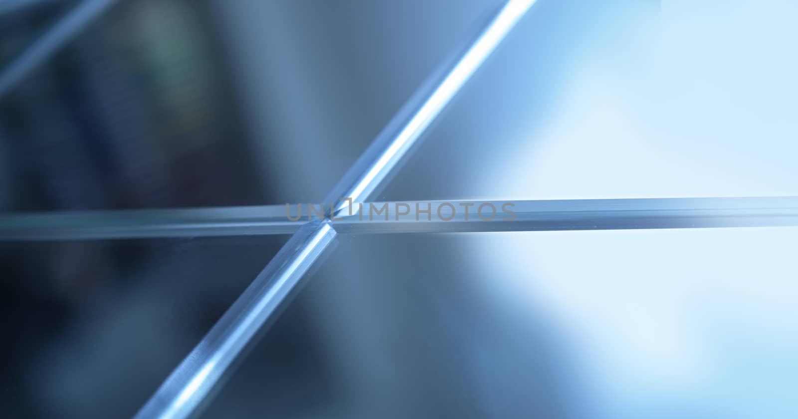 Glass, mirror reflection shapes and shadows. Close-up details.  Abstract geometric design with parallel and intersecting lines. Graphical representation of angle