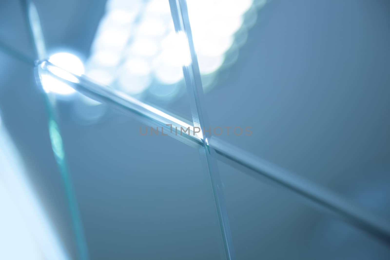 Glass, mirror reflection shapes and shadows. Close-up details.  Abstract geometric design with parallel and intersecting lines. Graphical representation of angle
