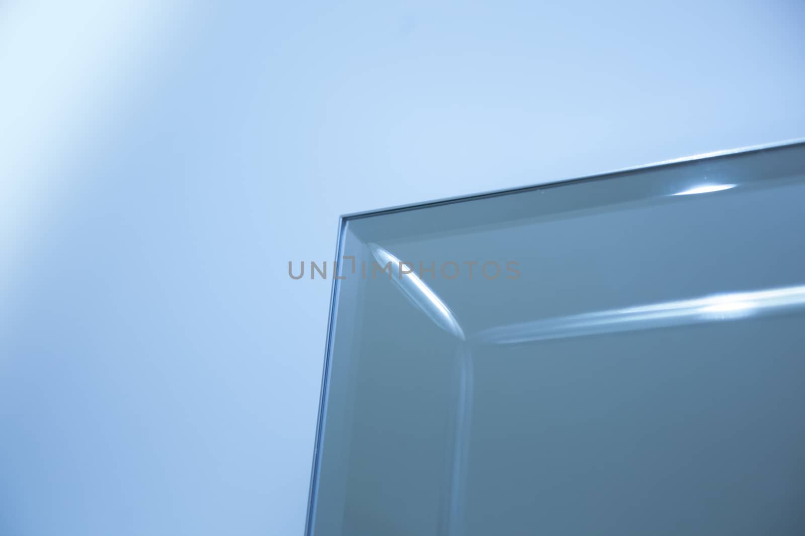 Glass, mirror reflection shapes and shadows. Close-up details.  Abstract geometric design with parallel and intersecting lines. Graphical representation of angle