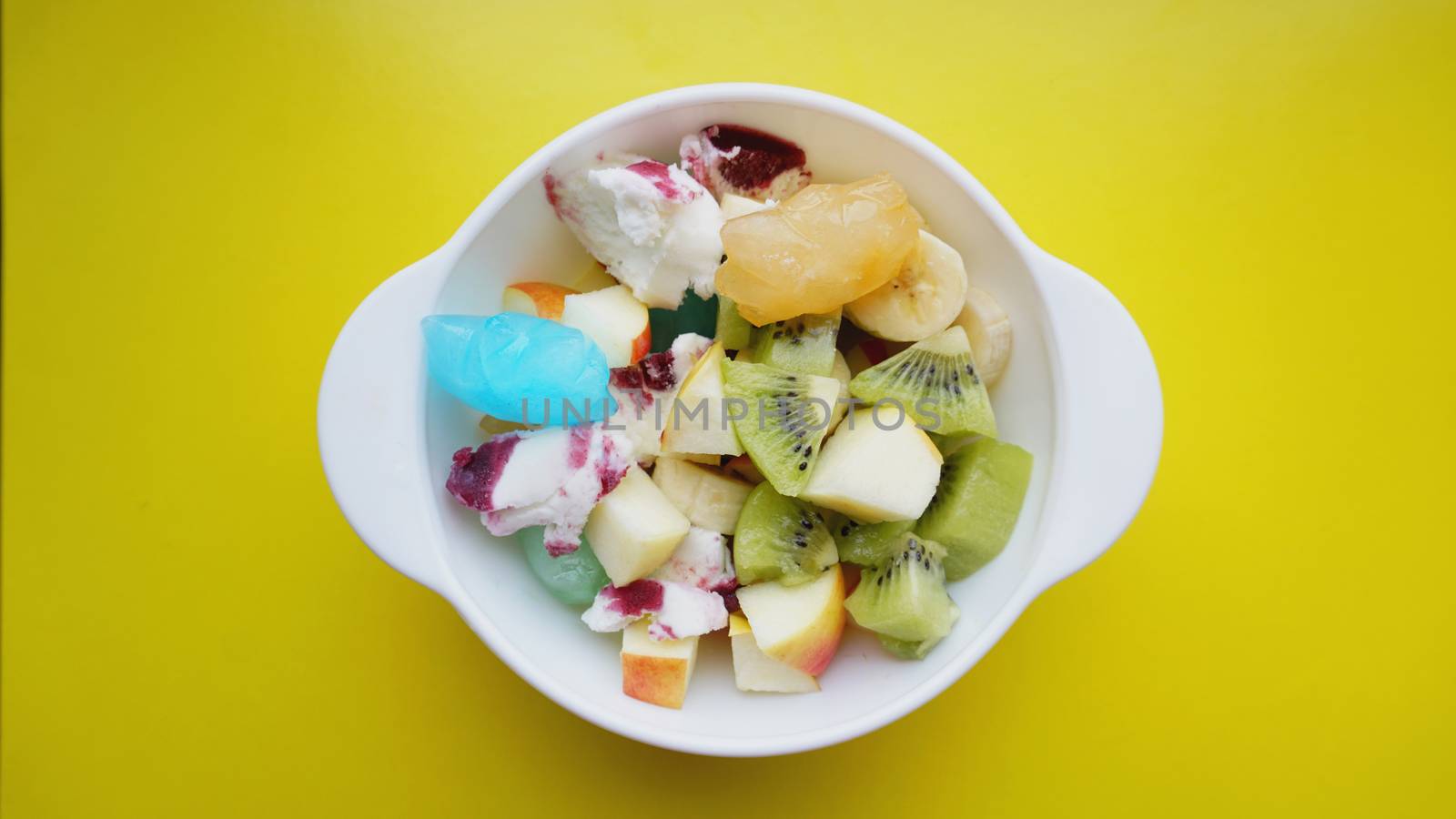 Close up desert with fresh fruit and ice cream. Mixed Fruit With with fruit ice on yellow background