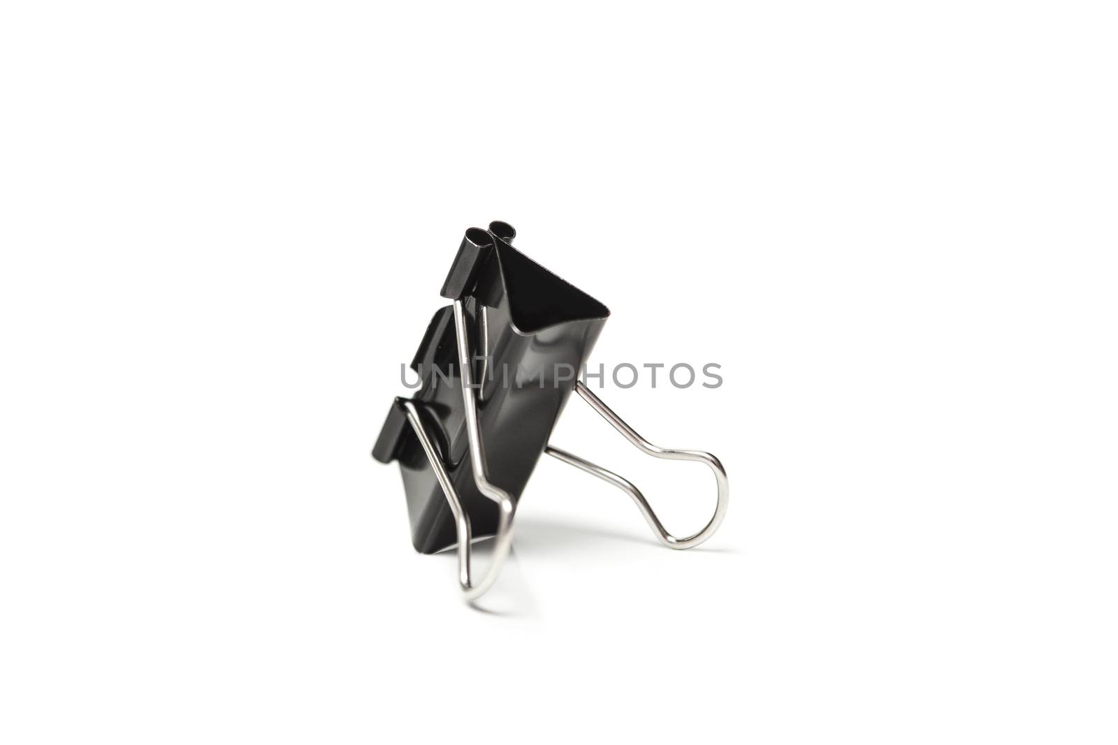 Paper clip isolated from white background. A paperclip is a device for office use to clamp a device such as paper and more.