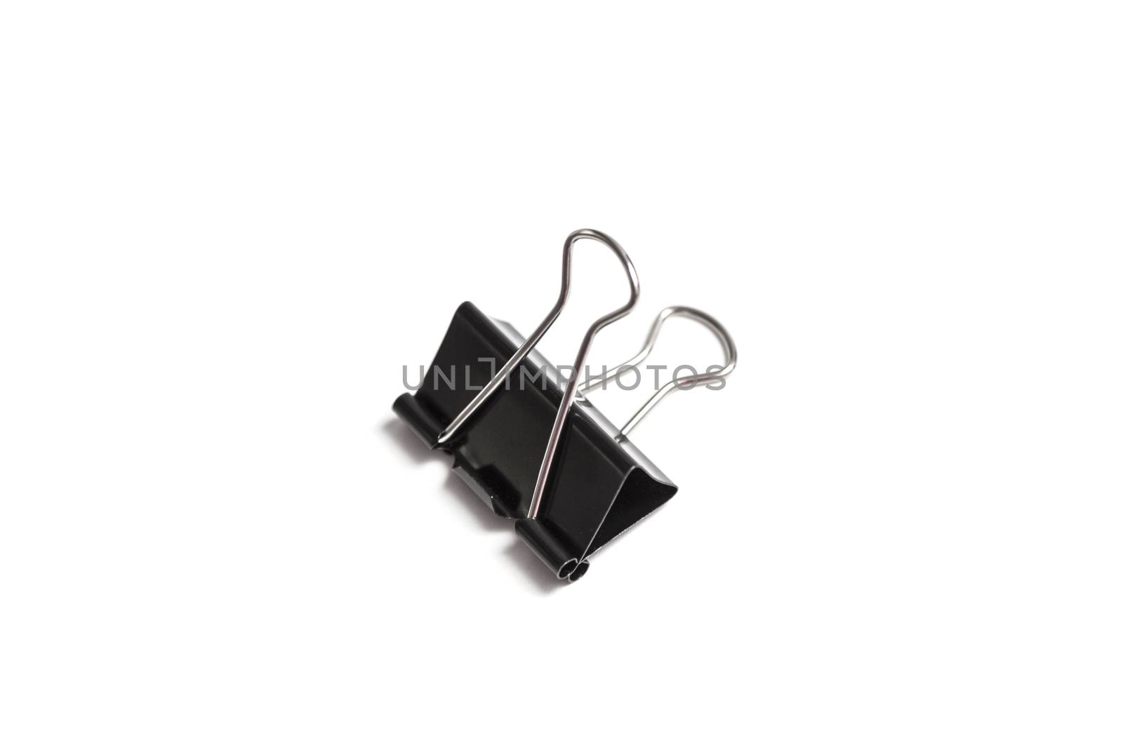 Paper clip isolated from white background. A paperclip is a device for office use to clamp a device such as paper and more.