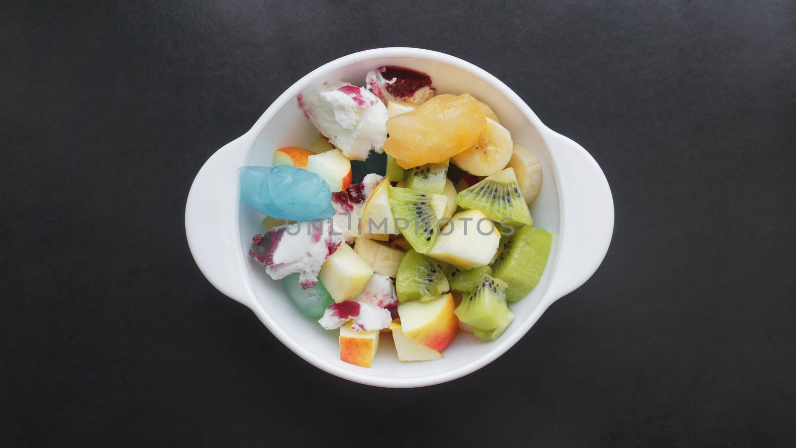 Close up desert with fresh fruit and ice cream. Mixed Fruit With Ice Cream and fruit ice on black background