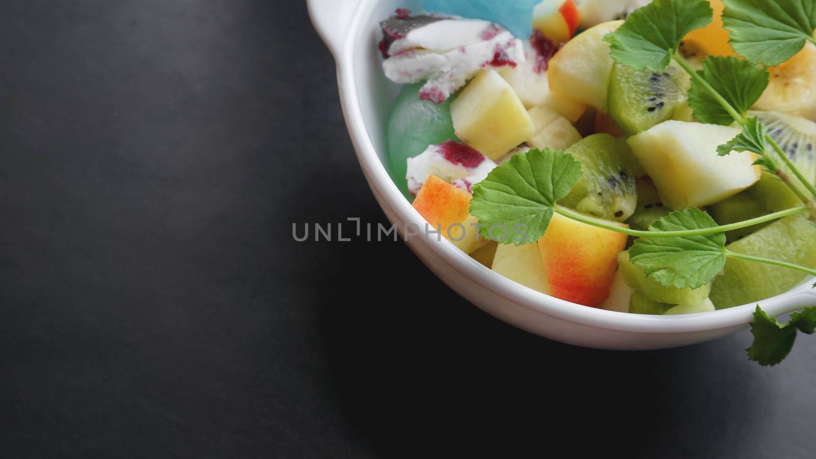 Close up desert with fresh fruit and ice cream. Mixed Fruit With Ice Cream and fruit ice on black background