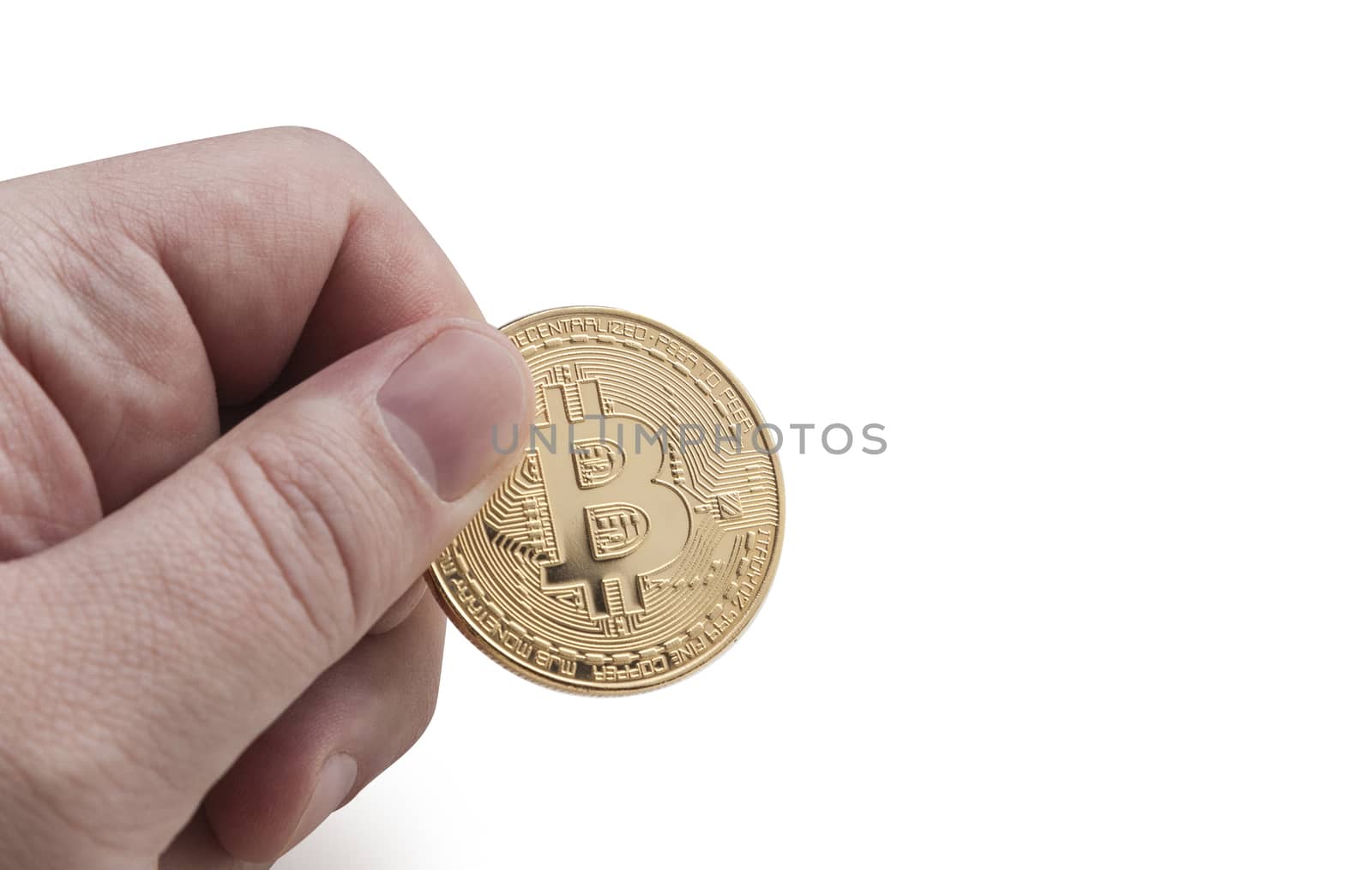 man's hand holding golden Bitcoin on a white background