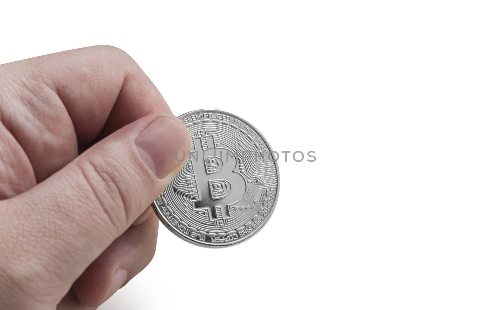 man's hand holding silver Bitcoin on a white background