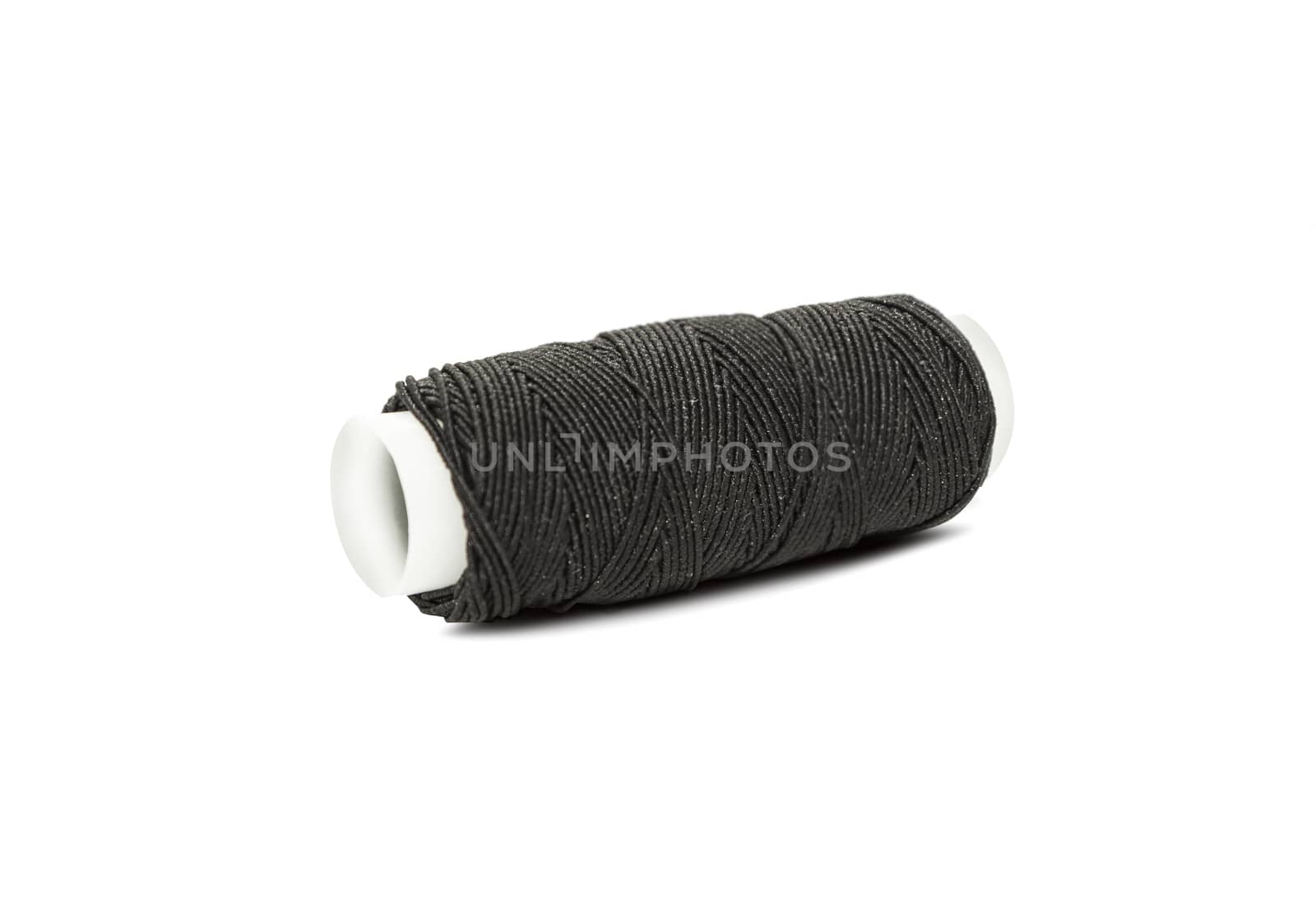 Black elastic thread on the coil horizontally isolated on white background