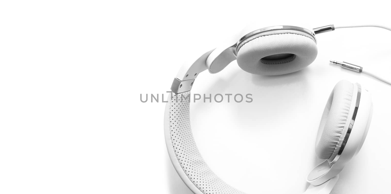 White headphones and Convention Aux cable 3.5 mm. Isolated on white background